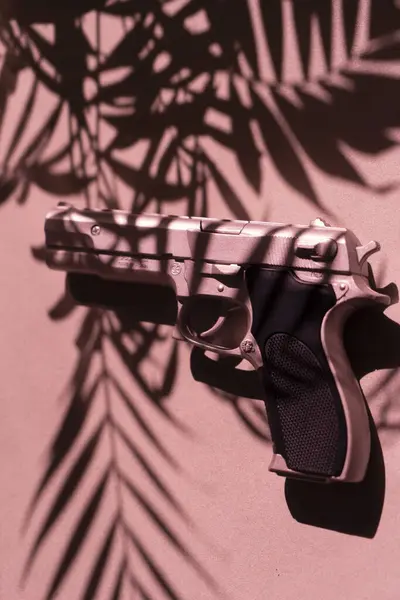 Spy thriller book cover design pistol gun.on floor with tropical palm tree shadows