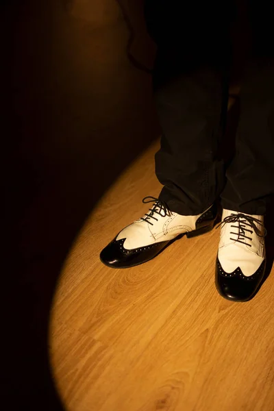 Male dancer teacher dancing in nightclub ballroom in jazz dance shoes.