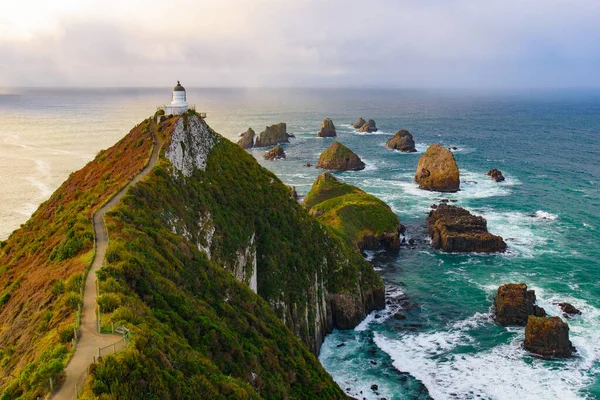 Nugget Point and lighthouse with sunrise at South Island, New Zealand