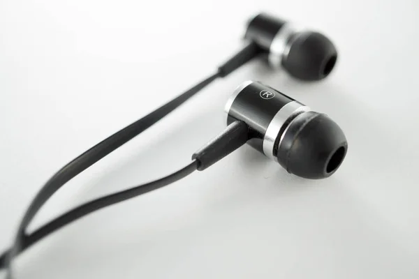 stock image Classic black ear bud headphones