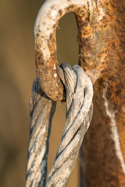 Stock image rusted pipe hook and cable