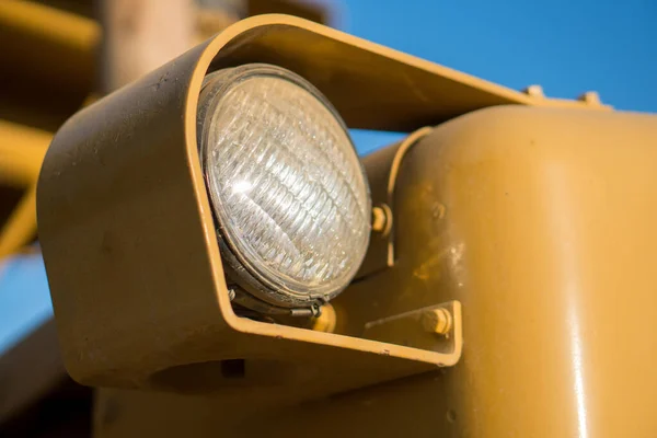 stock image old headlight on yellow tractor