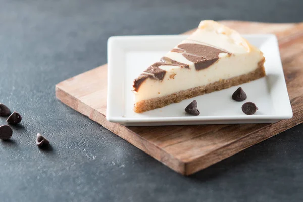 stock image dark Chocolate swirl cheesecake slice on square plate