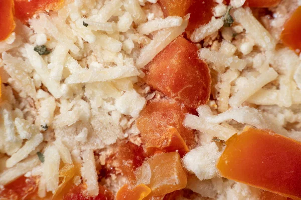 Frozen margarita pizza close up with cheese and diced tomatoes
