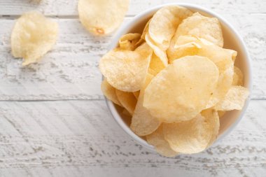 Bir kasede patates cipsi yığılıyor.