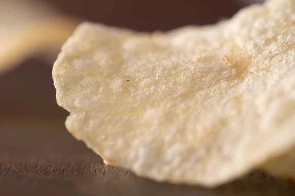 stock image Potato chips scattered on table