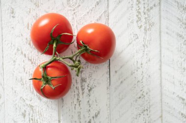 Beyaz kırsal masada olgun kırmızı domatesler.