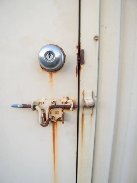 stock image rusted yellow steel door handle and latch