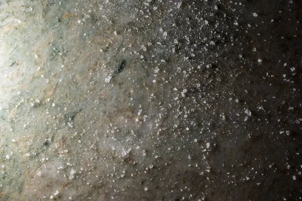 Crushed salt on green granite counter top food background