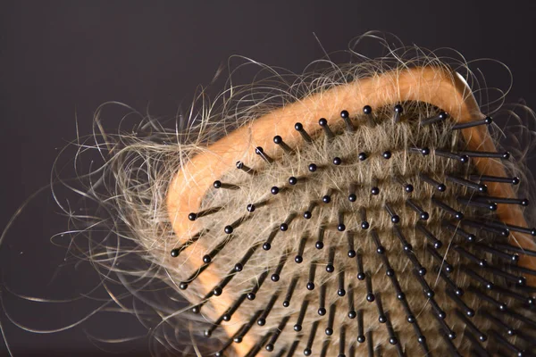 Closeup Wood Hairbrush All Covered Blond Female Hair Gray Background — Stock Photo, Image