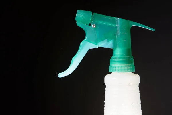 stock image White and green spray water bottle with black background