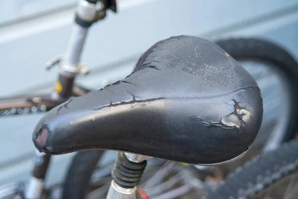 Old Weathered Tearing Black Bicycle Seat — Stock Photo, Image