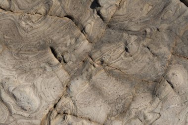 Yaratıcı kıvrımlı doğal desenli eski kaya yüzeyinin güzel soyut arkaplanı