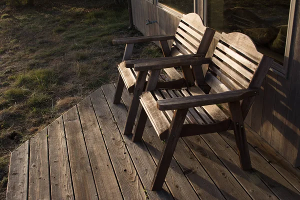 stock image Two wood chairs on a deck outside