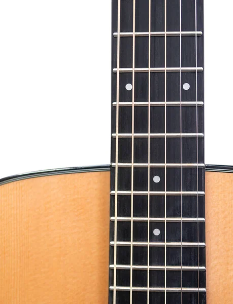 The neck of a six-string acoustic guitar on a dark background . guitar neck on a white background. Guitar fingerboard. selective focus.