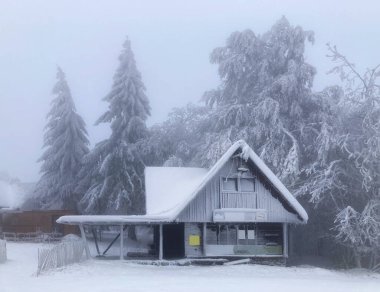 Frost hut at winter in mist forest