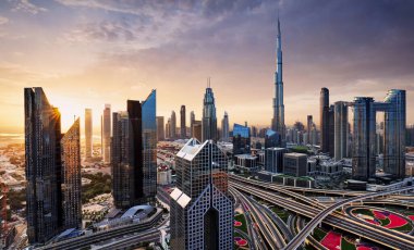 Dramatic sunrise over Dubai skyline panorama with Burj Khalifa and luxury skyscrapers, United Arab Emirates