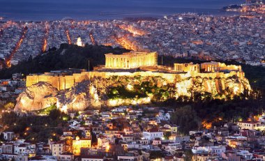 Cityscape of Athens with illuminated Acropolis hill, Pathenon and sea at night, Greece clipart