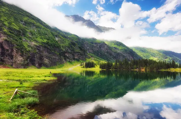 stock image Beautiful summer lake landscape with mountain in the Autria Alps. Wonderful hiking spot. Alpine lake with high mountains. Pine trees. Hohe Tauern near Zell am See / Kaprun