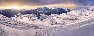 Panoramic view of beautiful winter wonderland mountain scenery in  mountain. background in the Alps in golden evening light at sunset. Austria - Obertauer clipart