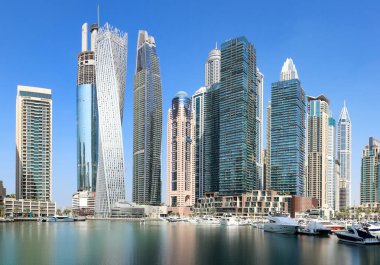 Dubai Marina at day with boat and blue sky, UAE