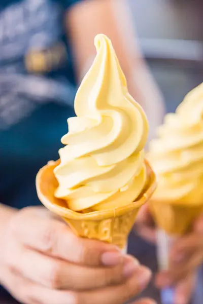 Mango soft cream in waffle cone.