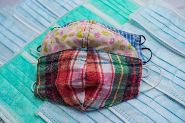 Cerrahi maske katmanının üzerine tekrar kullanılabilir bez maskeler, kovid 19 enfeksiyonunu önlemek için alternatif koruma.