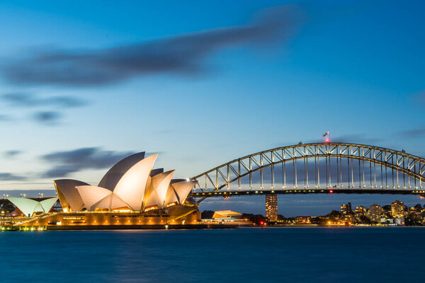 Sydney harbor skyline at night with Sydney harbor bridge and opera house, NSW, Australia.