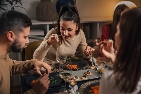 people eating at home dinner party