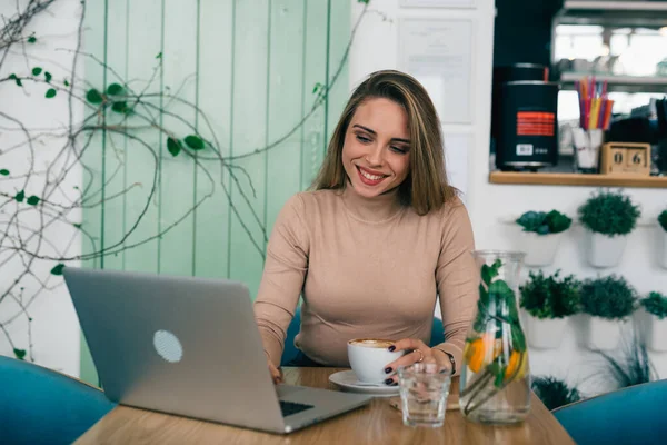 woman freelancer remote working from coffee shop