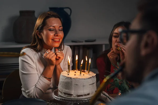 Adult birthday girl making a wish