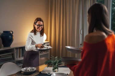 Masayı hazırlayan iki kadın.