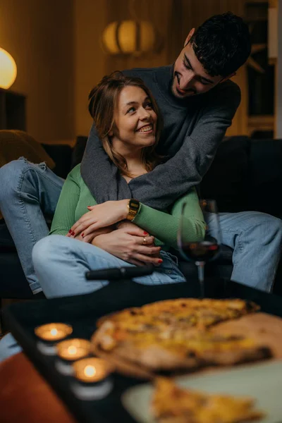 Young couple in love enjoys pizza at home
