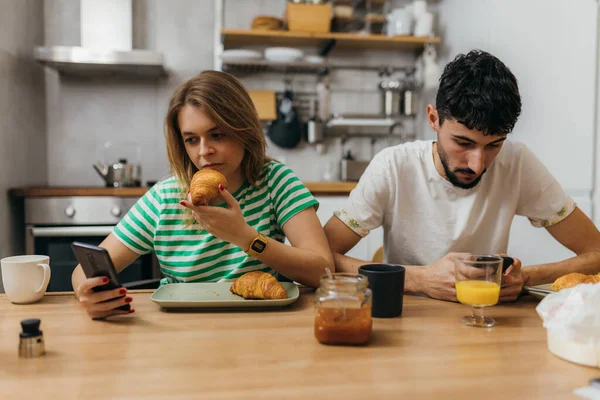 Young couple eats breakfast in silence