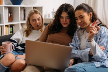 Friends spend their free time on online shopping