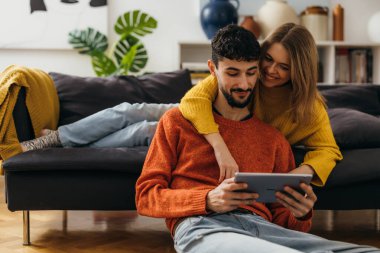 A young caucasian couple enjoys afternoon together at home