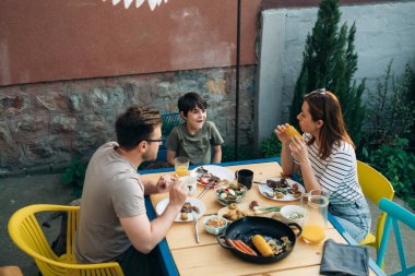 Caucasian family enjoys lunch in the garden on weekends