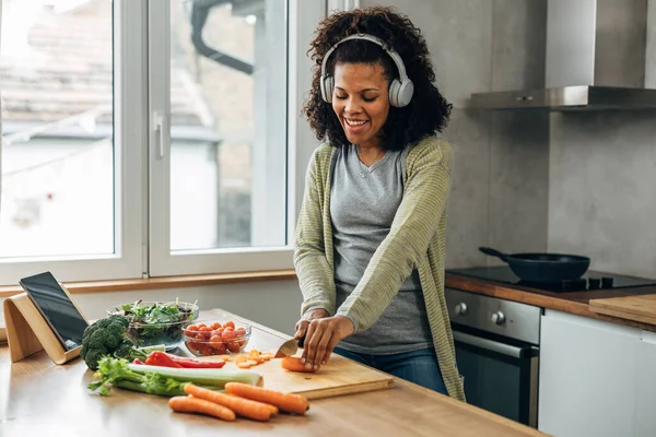 stock image Woman loves to listen to music when she cooks