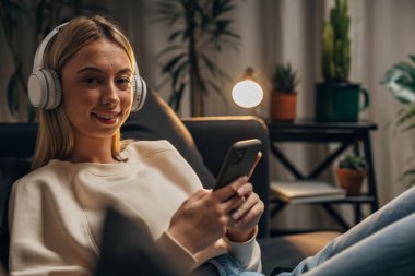 Yong blonde woman is spending her free time on social media