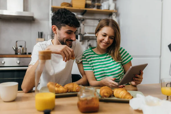 stock image A young couple is having breakfast together