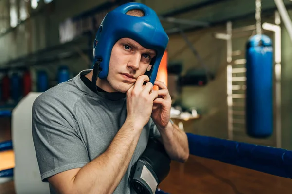 stock image A caucasian boxer is putting gum shield on his head