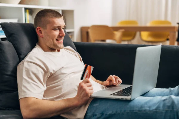 stock image A Caucasian man is contactless shopping online