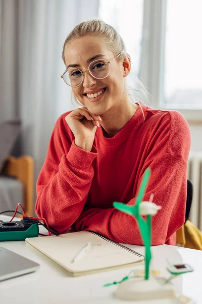 stock image A beautiful female student is studying about renewable energy resources on a model.