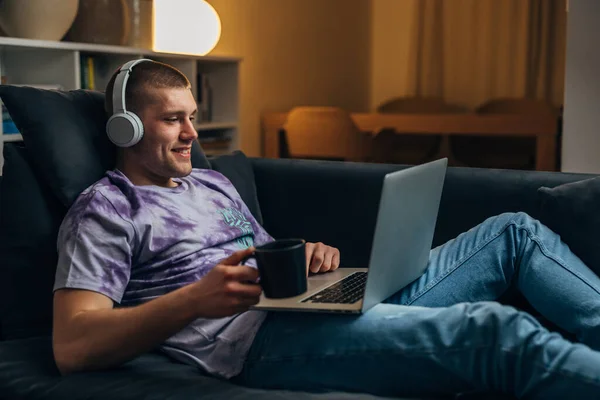 Ein Junger Kaukasischer Mann Benutzt Seinen Laptop Und Lächelt — Stockfoto
