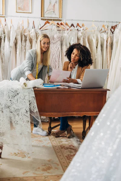 stock image Two women work in a bridal salon as a tailor and a designer