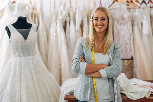 stock image A beautiful Caucasian woman is working in a bridal salon and looking at the camera