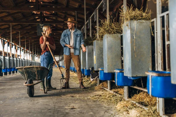 stock image A man and a woman standing in the animal farm and talking.