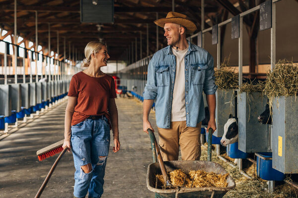 a woman and a man work together in a diary farm.