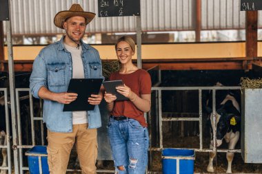 Hayvan çiftliğinde çalışan beyaz bir kadın ve adamın ön görüntüsü..