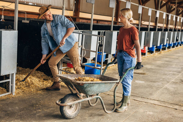 A woman and a man work in a stall.